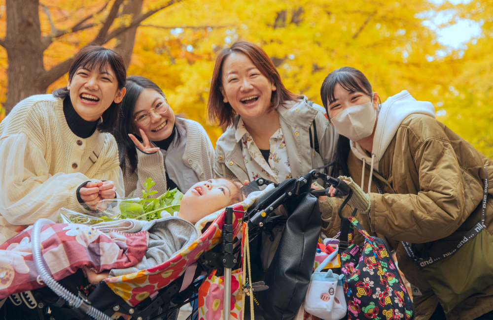 紅葉を楽しむ4人の女性と障がい児